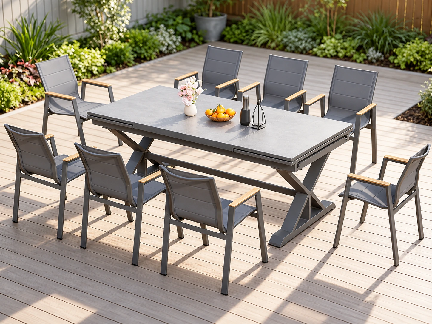 Rectangular grey outdoor table with crossed supports and surrounding dining chairs